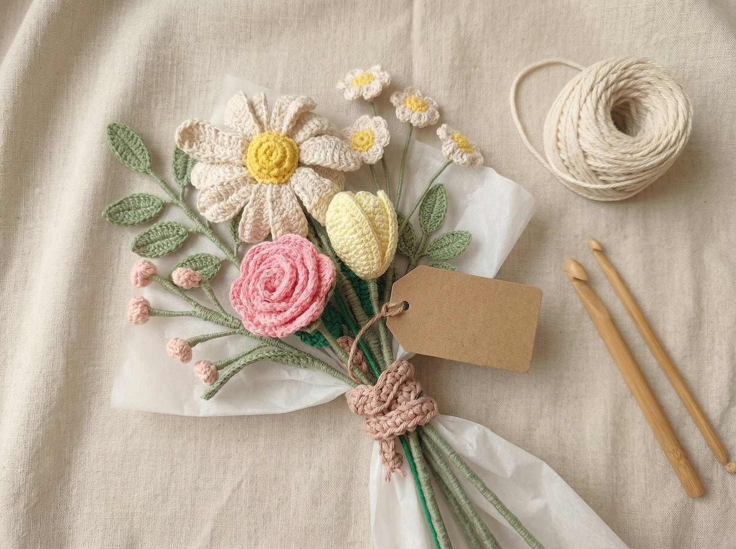 Knitted flowers with a tag and yarn on a beige fabric background